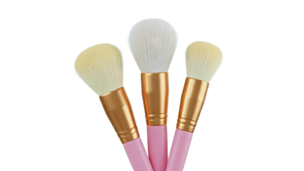 Three pink and gold makeup brushes with white and yellow bristles