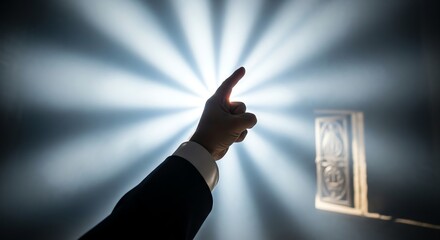 Hand pointing towards light with elevator button