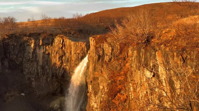 Cinematic Tilt Down of Hundafoss Waterfall, Light to Shadow, Iceland.