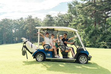 Male and female golfers riding golf carts at a golf course