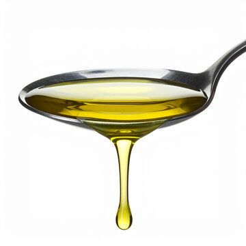 Spoonful of olive oil in the foreground on a white 
