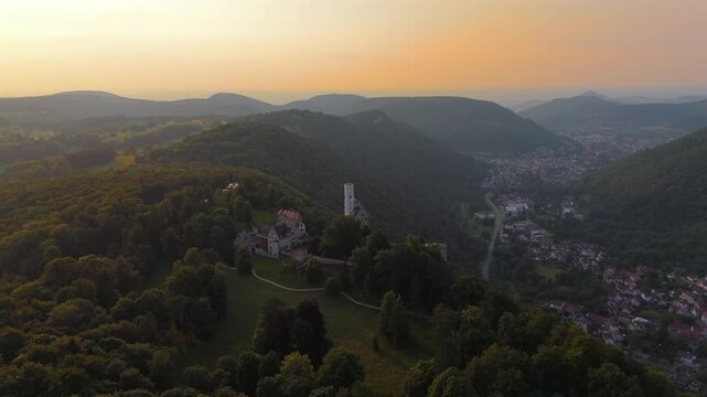 Schloss Lichtenstein, the fairy tale castle of Wuerttemberg, filmed by drone at sunset. Located above the Echaz Valley near Reutlingen, it offers stunning panoramic views of the Swabian Jura.