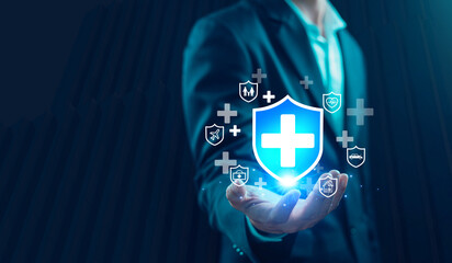 Business professional holding digital shield with medical cross icon, representing insurance protection, health coverage, risk management, security services, and corporate protection solutions.