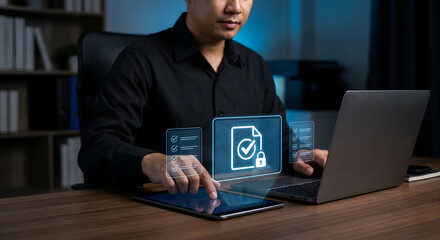 professional businessman using laptop and tablet for digital document verification secure data management electronic signature and online compliance checklist in modern office