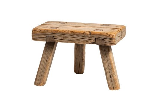 Antique, low, three-legged wooden taboret crafted from heavily weathered pine, showing deep gouges and rustic grain. Isolated studio shot on white background. Concept of historical authenticity