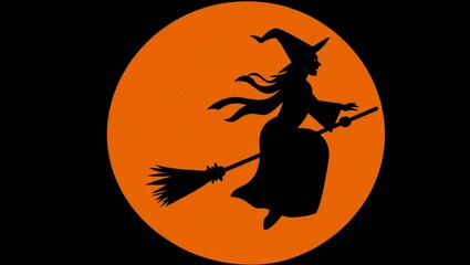 Silhouette of a witch flying on a broomstick against a large glowing orange moon on halloween night.
