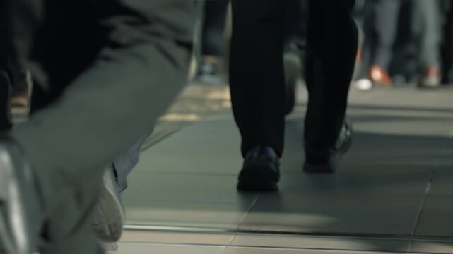 Low angle close up of business commuters walking on a busy Tokyo street.