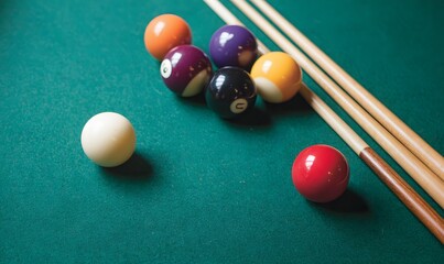 billiard balls and cues on a green table, taken from above