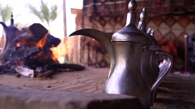 Traditional Arabic Coffee Dallah on Sand Fire in a Bedouin Tent with Authentic Desert Atmosphere