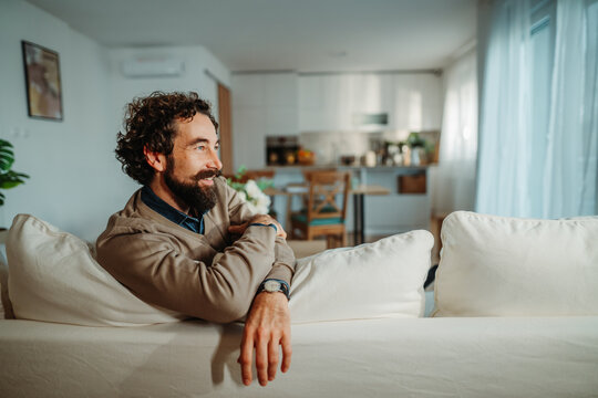 Man relaxing on sofa enjoying peaceful home lifestyle