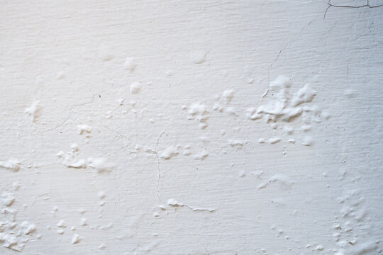 Peeling and Bubbling White Paint on Concrete Wall Texture Background