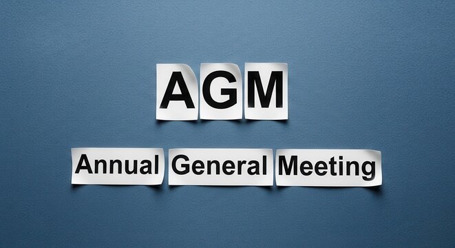 AGM - Annual General Meeting Concept on Blue Background.