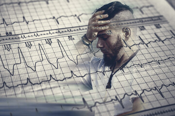 Worried adult male face over damaged electrocardiogram showing cardiac distress