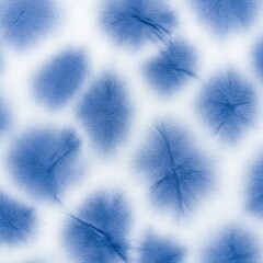 Abstract blue and white tie-dye pattern with blurred edges.