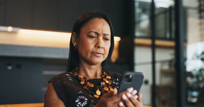 Confused, woman and reading in home with phone, unexpected news and text message for online gossip. Mature person, doubt and concern in house with tech, mobile chat and update for social media rumor.