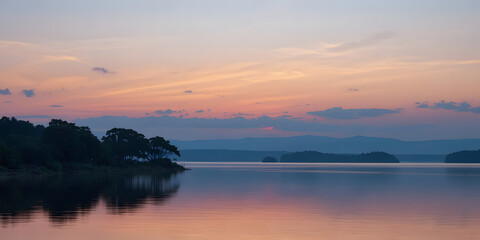Naklejka premium Serene lake at dusk with vibrant pink sunset colors