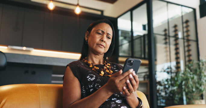 Confused, woman and doubt in home with phone, unexpected news and text message for online gossip. Mature person, concern and reading in house with tech, mobile chat and update for social media rumor.