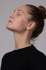 Naklejka premium Woman in profile with closed eyes and natural skin. Minimal portrait representing skincare, self care and authenticity.