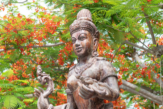 This is a statue of a Thai-style angel or deity, likely a Kinnari, often found in Buddhist mythology and art. 