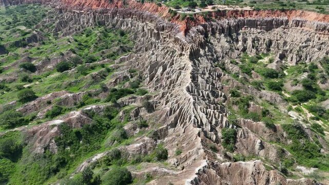 Cinematic drone footage of the unique red cliffs and eroded formations of the Viewpoint of the Moon (Miradouro da Lua) near Luanda, Angola Africa aerial travel destination
