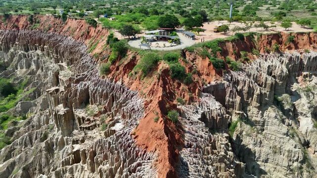 Cinematic drone footage of the unique red cliffs and eroded formations of the Viewpoint of the Moon (Miradouro da Lua) near Luanda, Angola Africa aerial travel destination