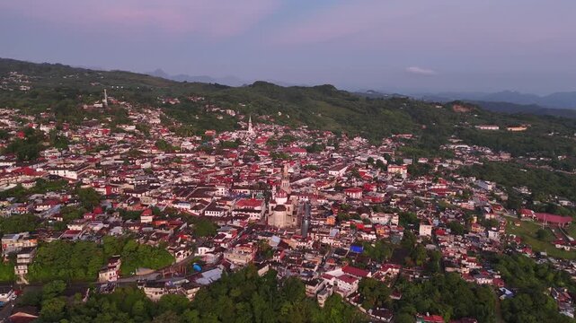 Hilltop town of Cuetzalan around it&acute;s main colonial church. Aerial