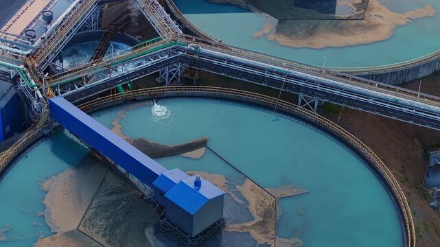 Aerial top view Industrial water treatment facility with sedimentation tanks pulp in copper mining factory.