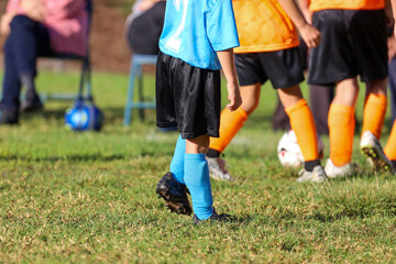 View of young kids in uniforms playing soccer. Youth soccer.