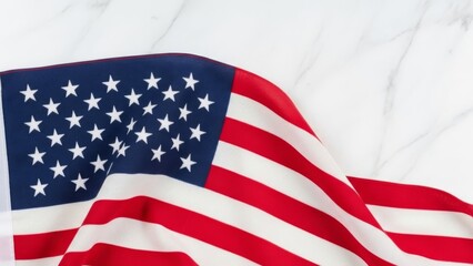 Obraz premium American flag draped on white marble surface. Close-up of stars and stripes waving gently against a clean, modern backdrop. Patriotic symbol with copy space.
