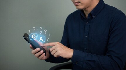 Man interacting with virtual Q and A interface on smartphone in modern dark blue attire with soft gray background for technology marketing