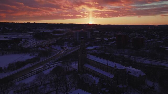 Orbiting around Hamilton Basilica and 403 at a moderate speed. Snow blankets the grown as the sun dips below the horizon on a cold winter night.