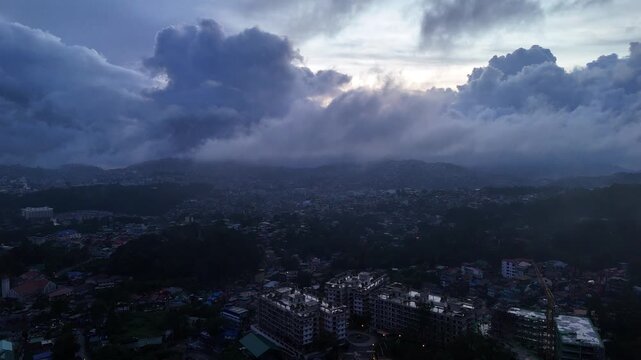 Cinematic Gloomy Aerial View of Baguio Cityscape at Dusk, Moody Foggy Atmosphere in Benguet Philippines
