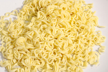Close up of cooked instant curly noodles on white background