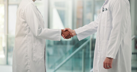 Shaking hands, doctors and welcome at clinic, lobby and thanks with agreement for hiring. People, medical staff and handshake for success, recruitment or deal with onboarding in hospital hallway