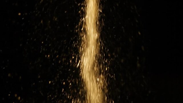 An abstract motion of white liquid water splashes and drops exploding against a dark black space like a starry galaxy night