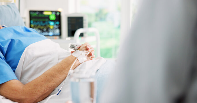 Elderly patient, hands and iv drip in hospital bed with doctor, medicine and recovery from surgery. Space, old woman and healthcare worker in medical clinic with intravenous fluid, help and support.