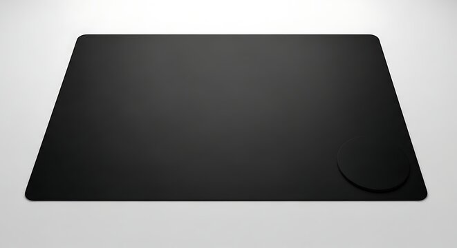 Blank black mouse pad with rounded corner on white background.