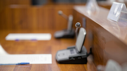 Delegate speakerphone unit in an empty boardroom. Concept of waiting for a political announcement, business seminar, or press debate. Photo