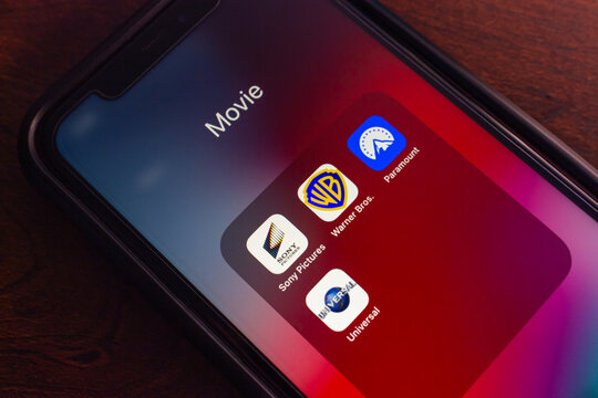 Mexico City, MEXICO - Apr 25 2025 : Close-up of a smartphone screen folder labeled "Movie" with icons for Sony Pictures, Warner Bros., Paramount, and Universal apps.