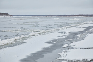 Winter landscape: ice drift on a river in cloudy weather © ILIA