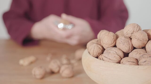 Using a nutcracker to crack a walnut