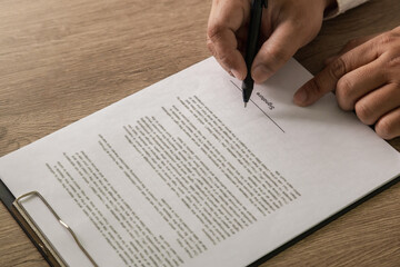 Business agreement concept, a person signing contract document at desk, marketing finance...