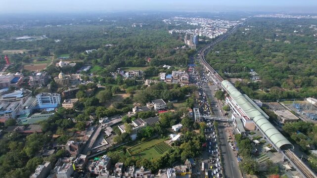 Aerial view of Delhi Metro with road traffic at Chhatarpur Metro Station, New Delhi, India