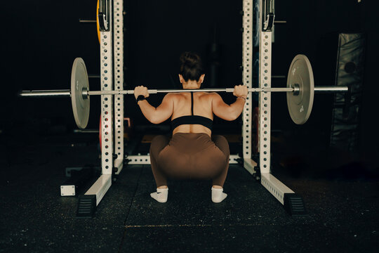 Athlete woman doing fitness training at the gym.  Workout and indoor sport.