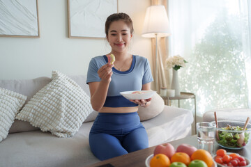 Young woman eating healthy fruit snack at home