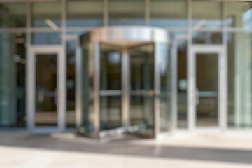Blurry Protected entrance gate - secured turnstiles outdoors. Steel revolving turnstiles at the entrance of production or metro station