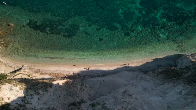 Spiaggia di Sansone Beach, Elba Island Italy &ndash; Drone Descending Arc at Sunrise Revealing Turquoise Shoreline