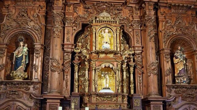 Main altarpiece of a Spanish Catholic church. Polychrome figures carved in wood. Catholic religious icons. Spanish Catholic religious art. Church of San Mateo. C&aacute;ceres. Spain.
