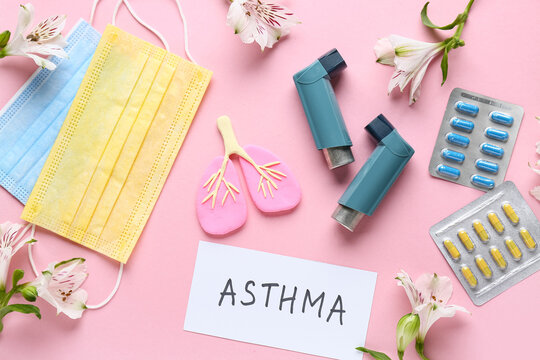 Word with ASTHMA with inhalers, medical mask and alstroemeria flowers on pink background