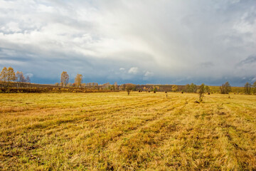 A mown field in late autumn on a cloudy day